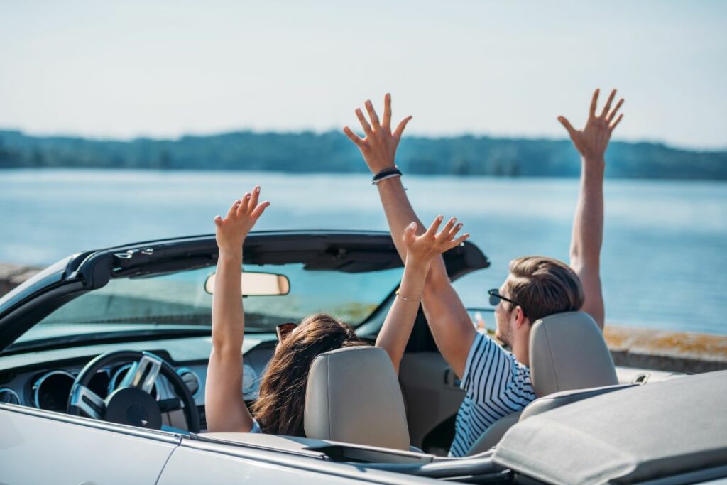 Vacation couple in convertable via Deposit Photos