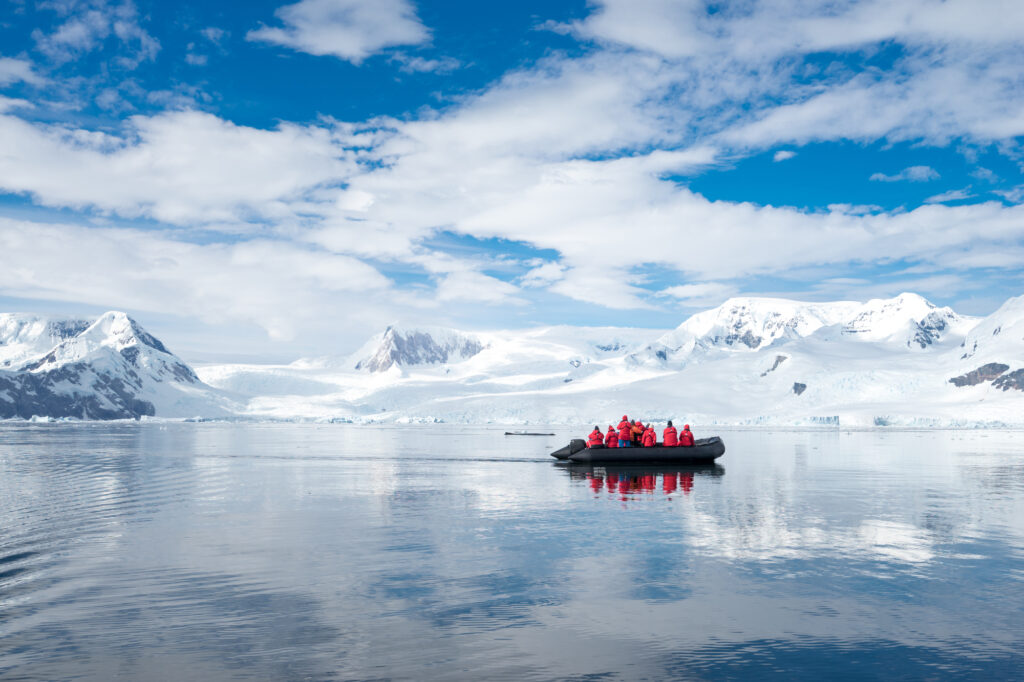 Inflatable boat full of tourists, watching for whales and seals, Antarctic Peninsula, Antarctica