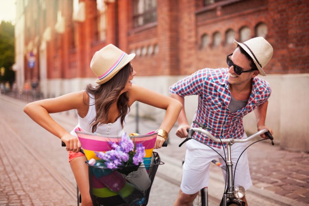 Happy couple chasing on bike in the street