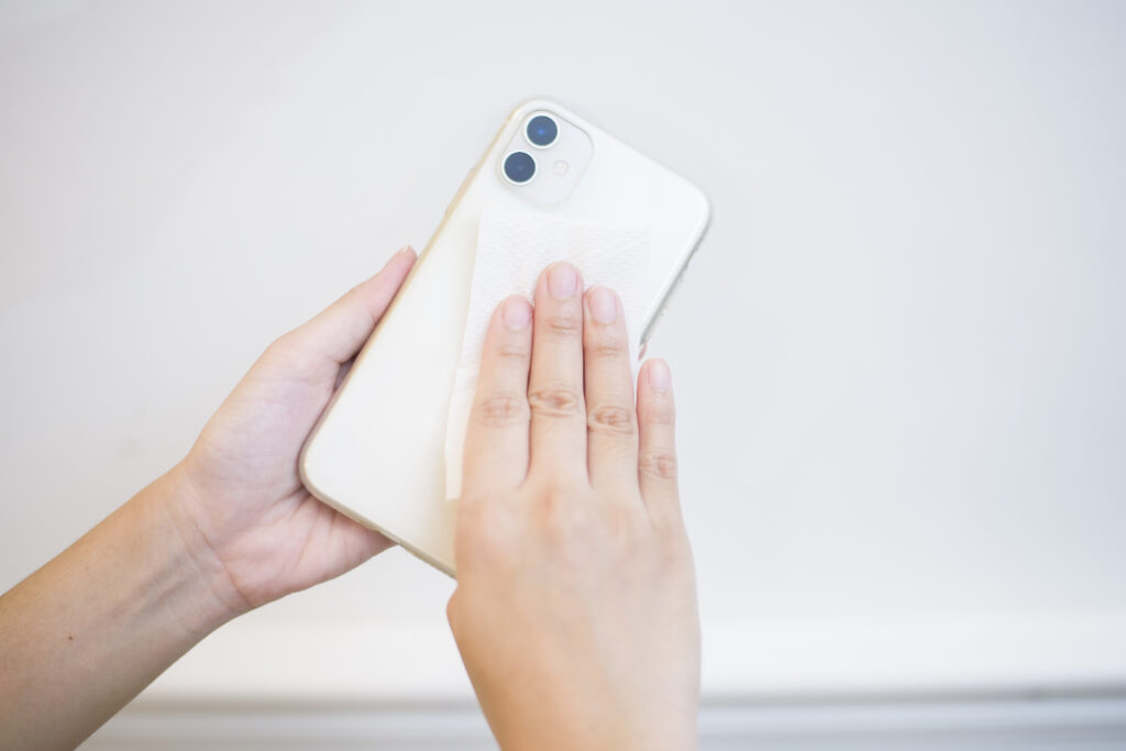 woman is cleaning cell phone