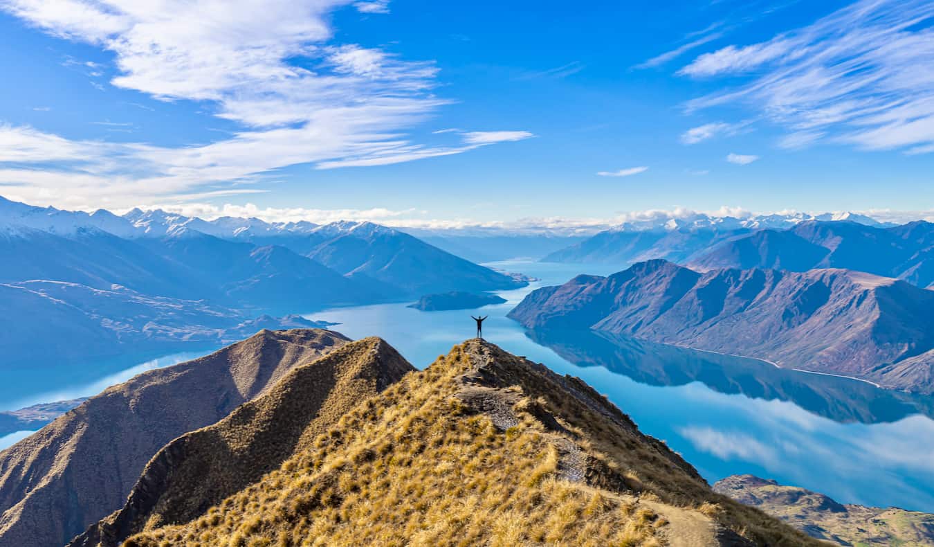 A solo hiker climbing the hills on scenic New Zealand on a beautiful day