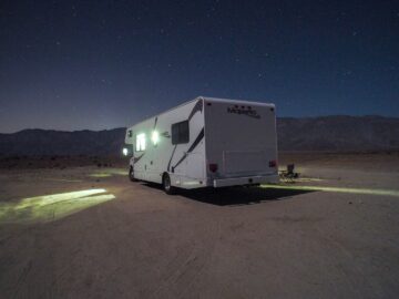 RV parked at night under a starry sky