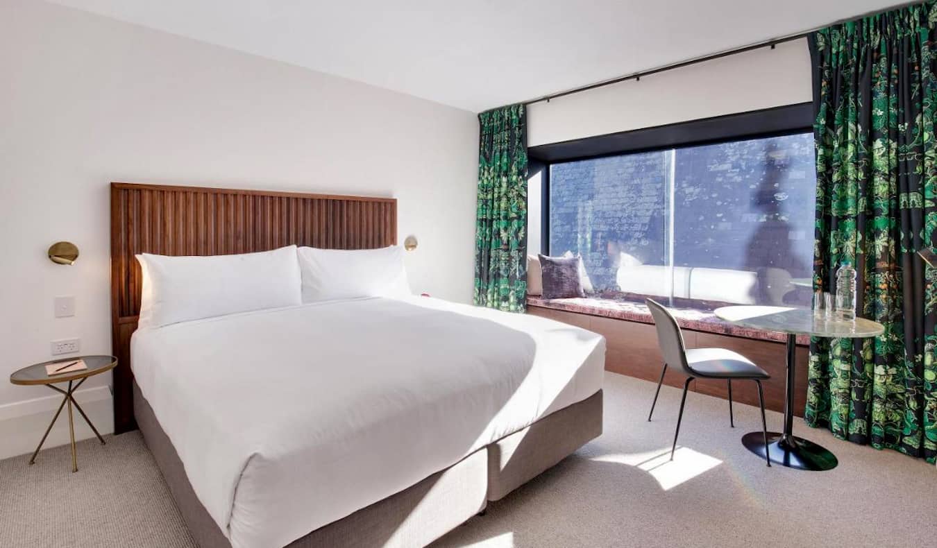 A large and spacious hotel room with a huge bed at the Crystalbrook Albion in Sydney, Australia