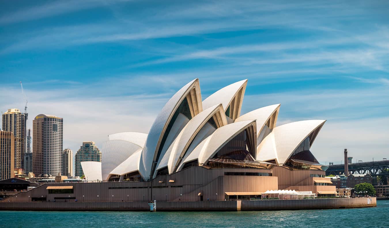 The iconic Sydney Opera House on the shore of the city on a beautiful, sunny day