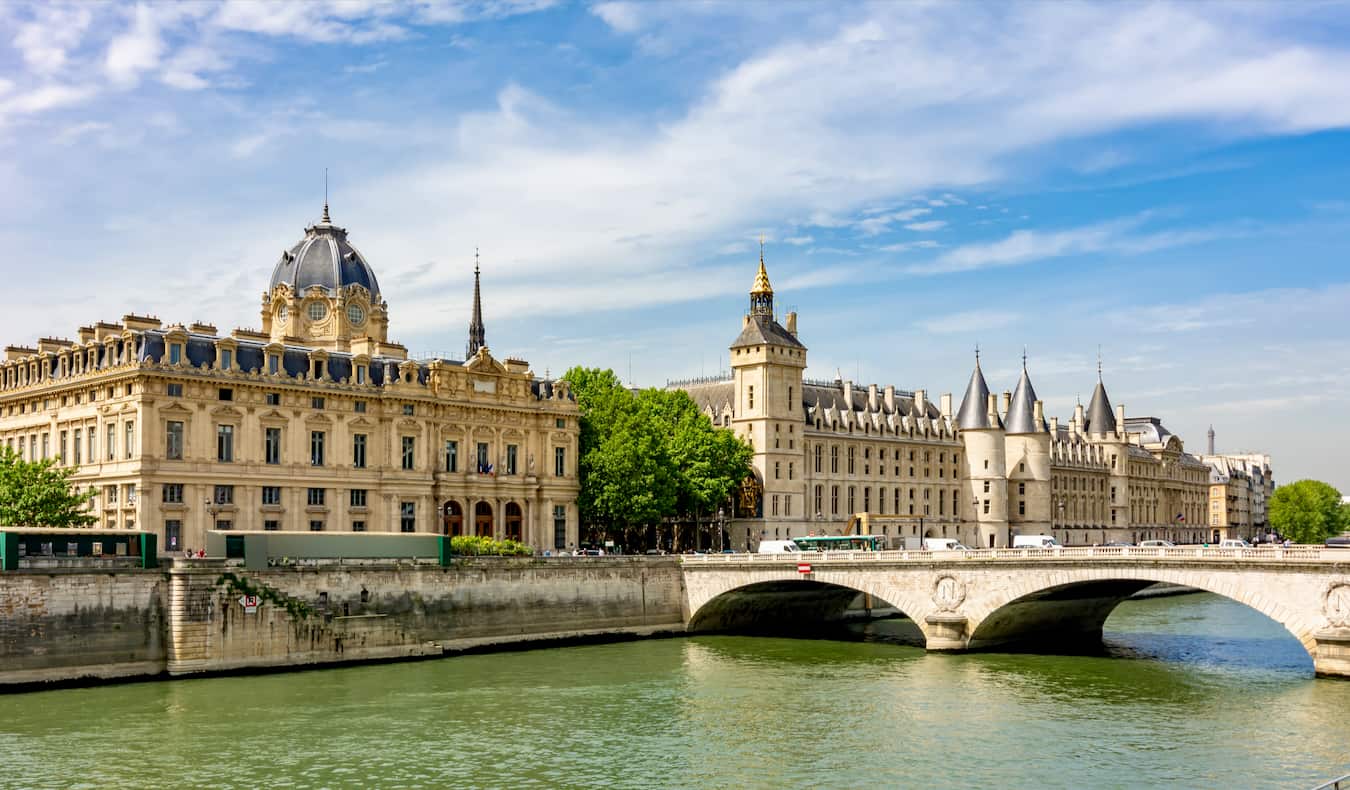 A sunny day looking over the river in Paris, France with old buildings in the background